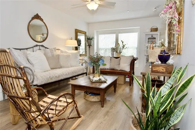 a living room with furniture a large window with wooden floor