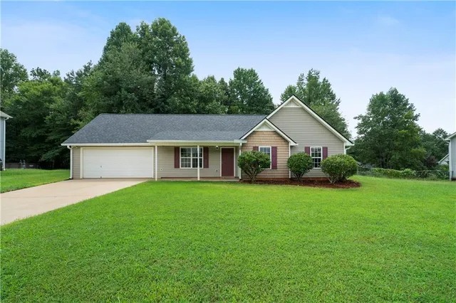 a front view of house with yard and green space