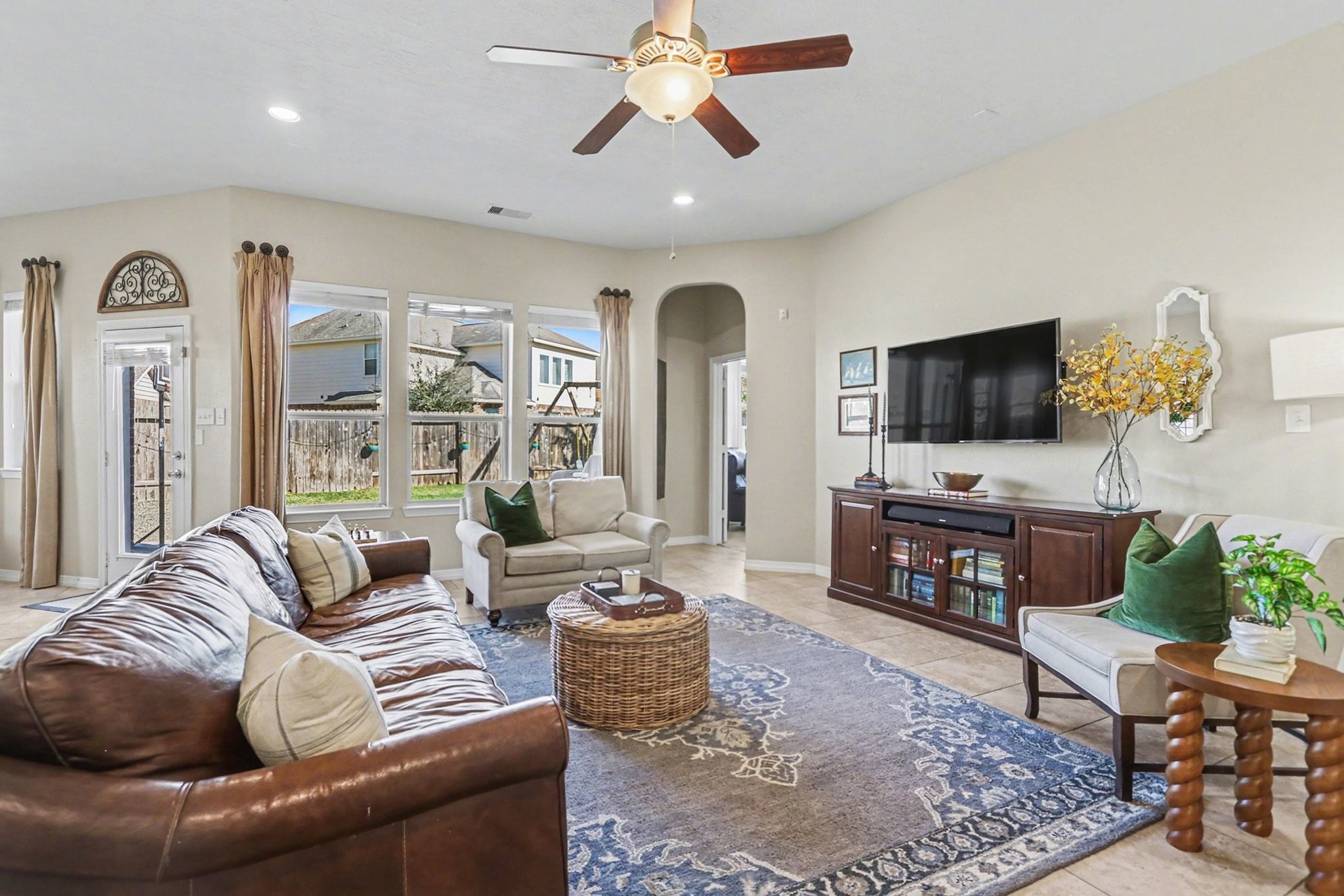 27006 Cliff Pointe Lane Katy, TX 77494 - Photo 6 of 34 Spacious and inviting living area featuring recessed lighting, ceiling fan, and large windows that fill the space with natural light—ideal for everyday living and entertaining.