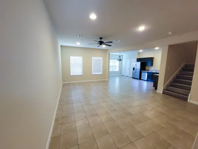 a view of a hallway with entryway and kitchen