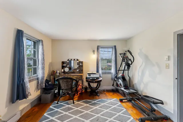 a view of a workspace with furniture and a gym