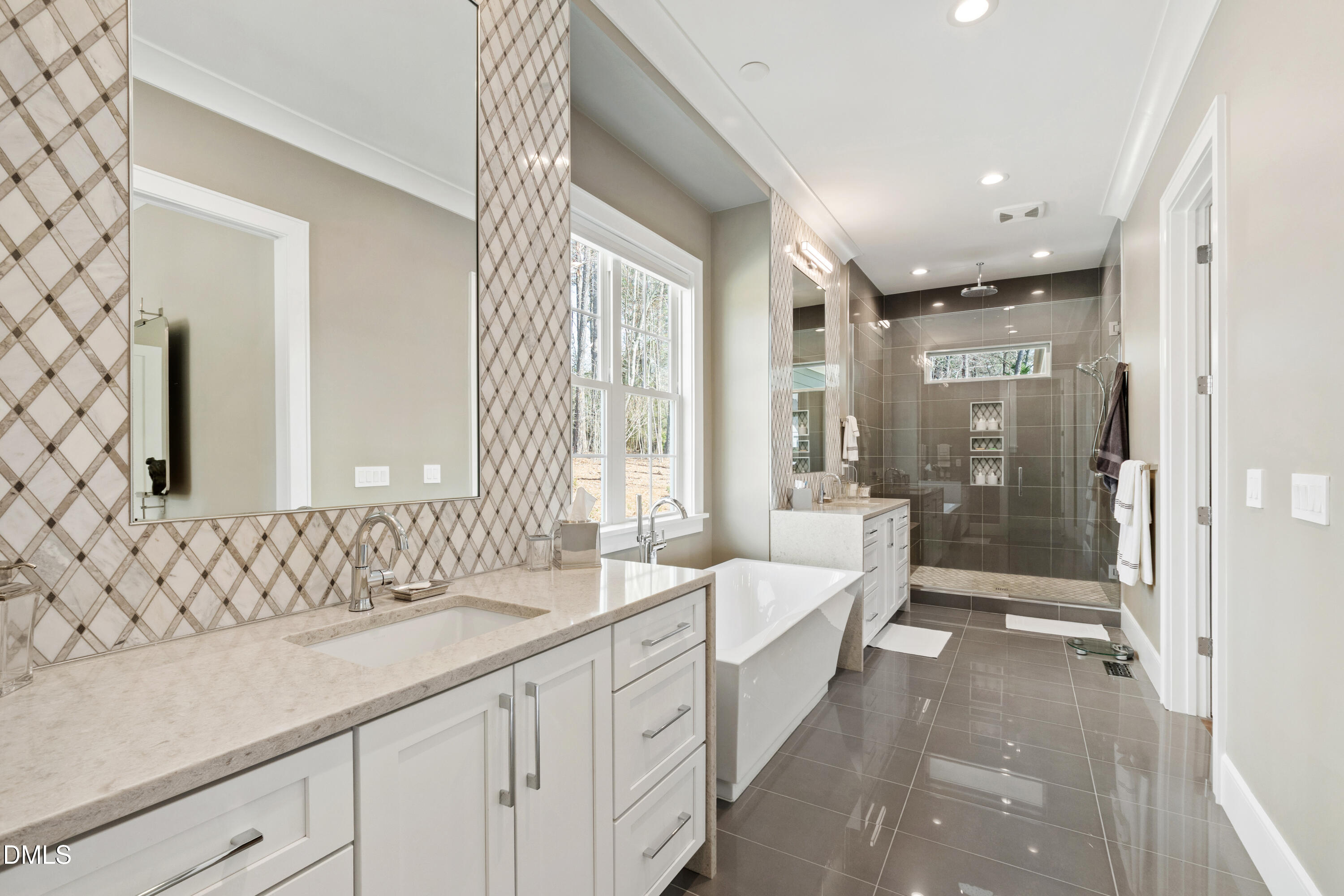 2721 Sanctuary Woods Lane Raleigh, NC 27606 - Photo 23 of 50 a spacious bathroom with sinks mirror and a shower
