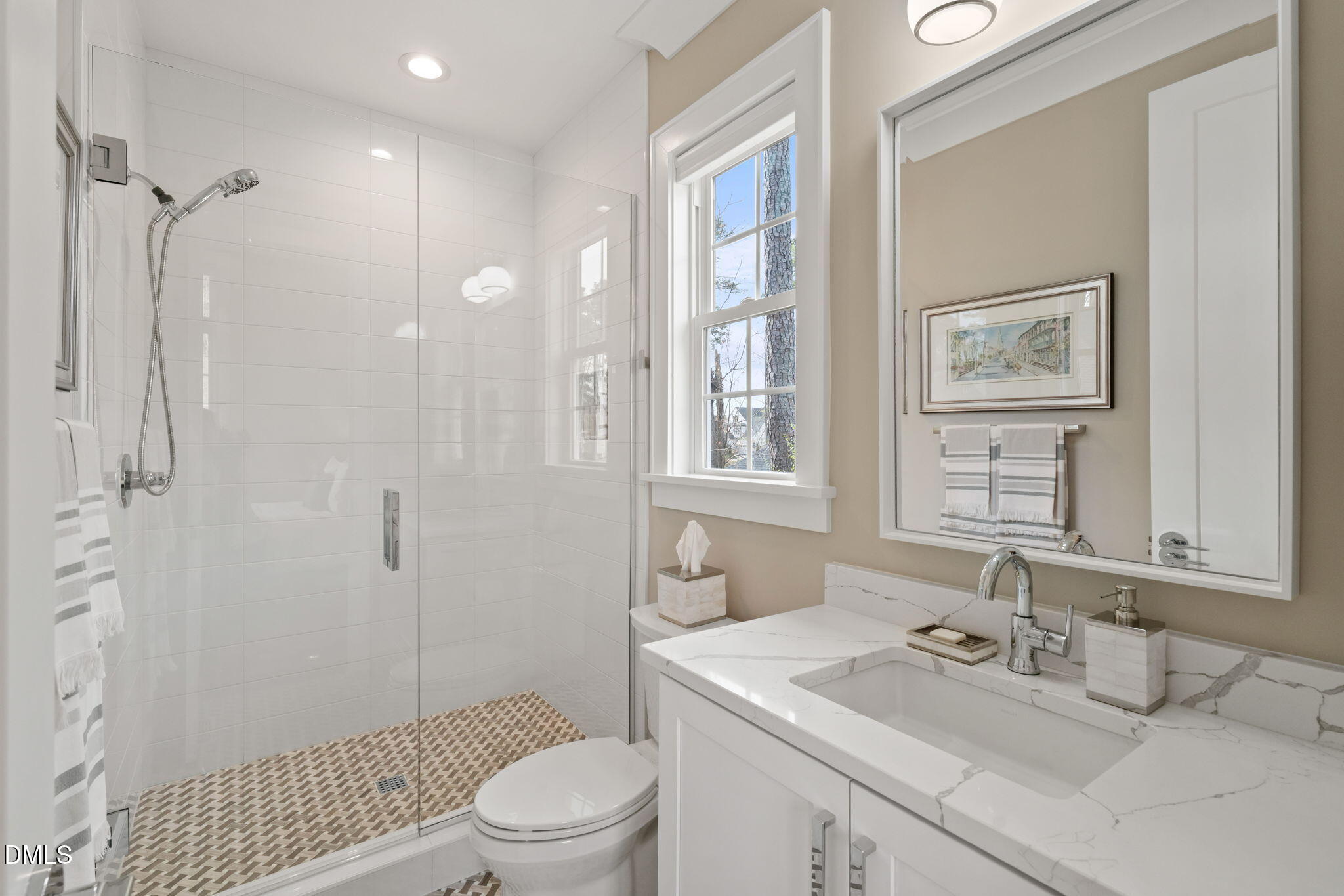 2721 Sanctuary Woods Lane Raleigh, NC 27606 - Photo 29 of 50 a bathroom with a sink a toilet and shower