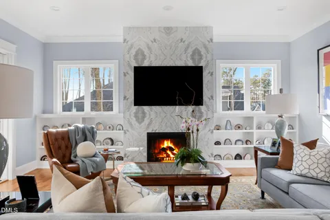 a living room with furniture fireplace and a potted plant