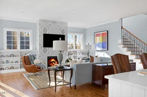 a living room with furniture a flat screen tv and a fireplace