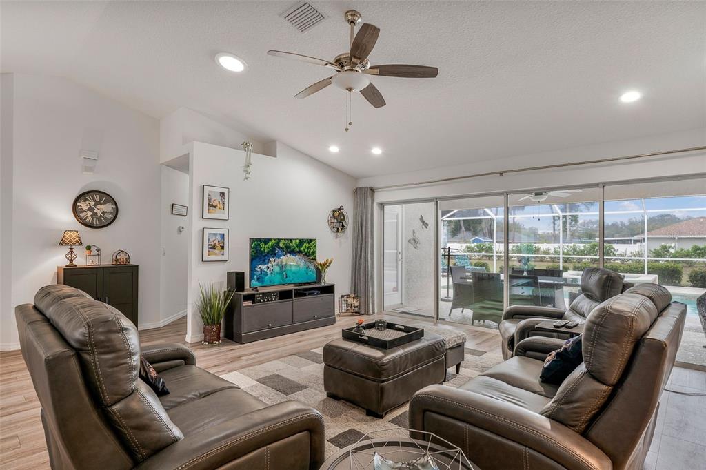 276 North Cunningham Avenue Inverness, FL 34453 - Photo 17 of 48 a living room with furniture ceiling fan and a large window