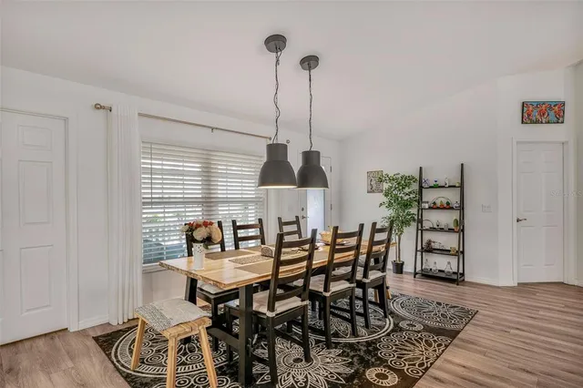 a dining room with furniture and wooden floor