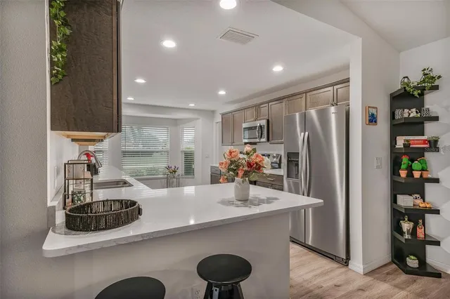 a kitchen with refrigerator and window