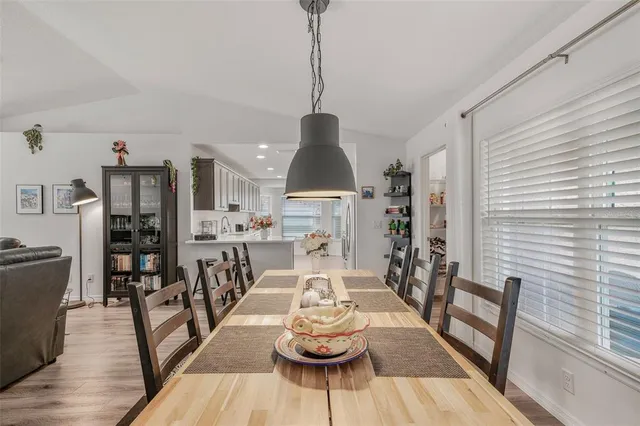 a dining room with furniture and wooden floor