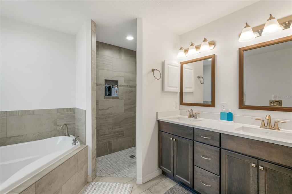 276 North Cunningham Avenue Inverness, FL 34453 - Photo 31 of 48 a bathroom with a tub a double vanity sink and mirror