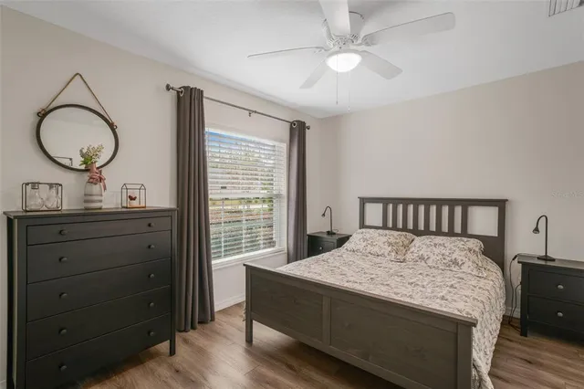 a bed room with a bed and a mirror