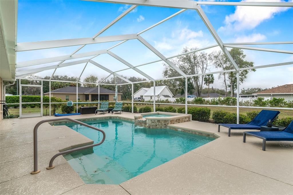 276 North Cunningham Avenue Inverness, FL 34453 - Photo 43 of 48 a view of a swimming pool with couches chairs and wooden fence
