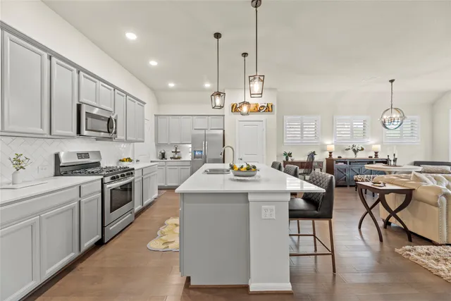 a kitchen with sink stove and cabinets