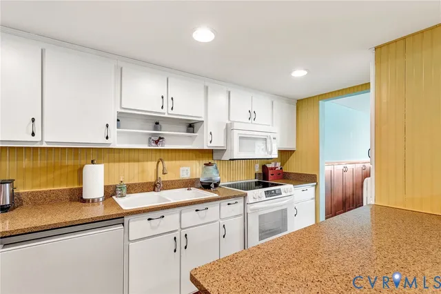a bathroom with a sink a light fixture and a mirror