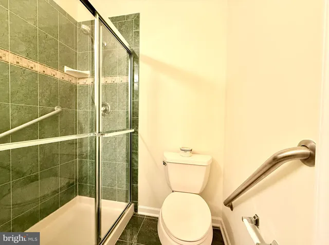 a bathroom with a toilet and a shower
