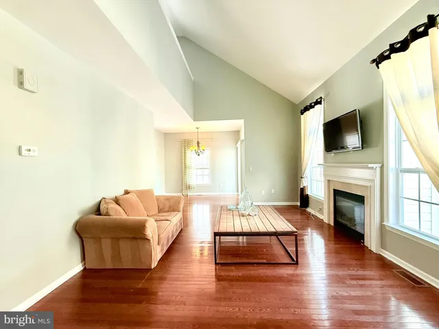 a living room with fireplace furniture and a flat screen tv