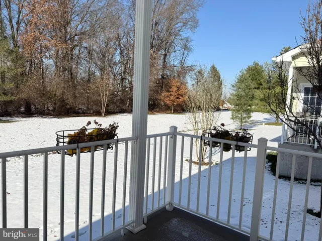 a view of a deck with chairs and wooden fence
