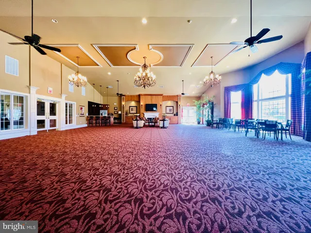 a large kitchen with stainless steel appliances granite countertop a lot of counter space and a sink