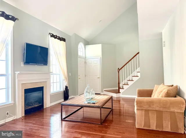 a living room with furniture fireplace and window