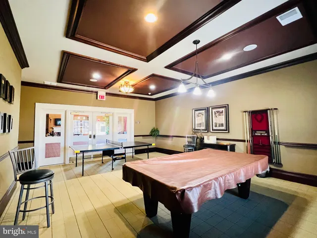 a living room with lots of furniture and a large window