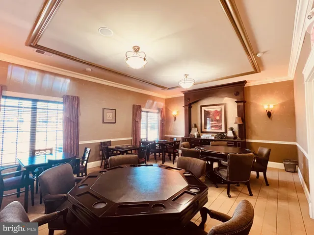 a living room with patio furniture and a flat screen tv