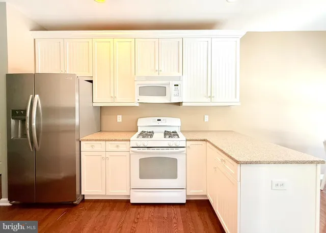 a kitchen with a stove top oven and refrigerator