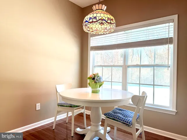 a view of a dining room with furniture and window