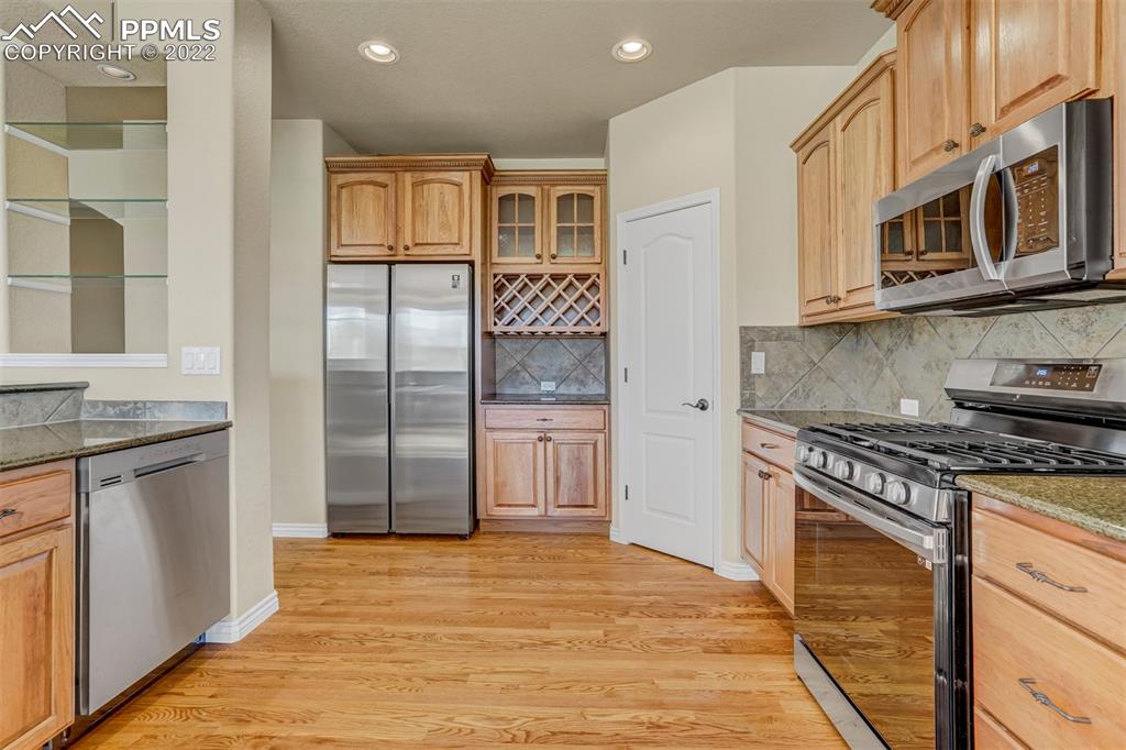 2664 Cinnabar Road Colorado Springs, CO 80921 - Photo 19 of 50 a kitchen with stainless steel appliances granite countertop a stove and a refrigerator