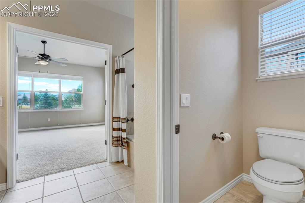 2664 Cinnabar Road Colorado Springs, CO 80921 - Photo 28 of 50 a bathroom with a toilet a sink and window