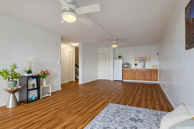 a open kitchen with kitchen island white cabinets and stainless steel appliances
