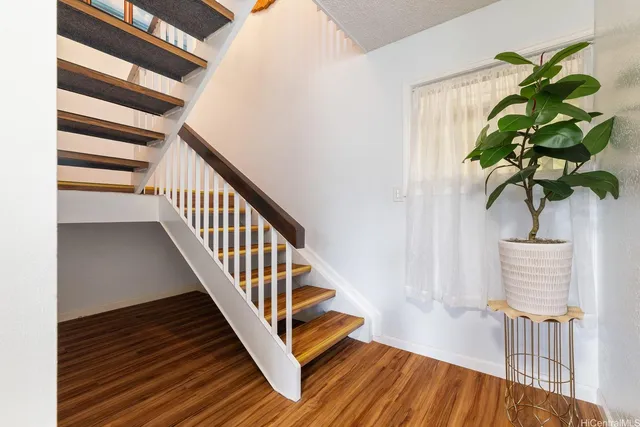 a vase of flowers sitting on a wooden floor