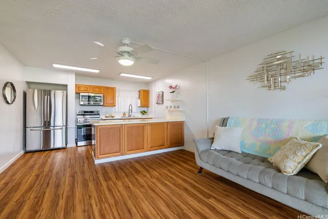 a living room with furniture and kitchen view