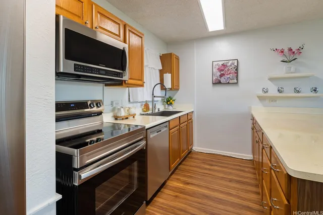 a kitchen with a sink and wooden floor