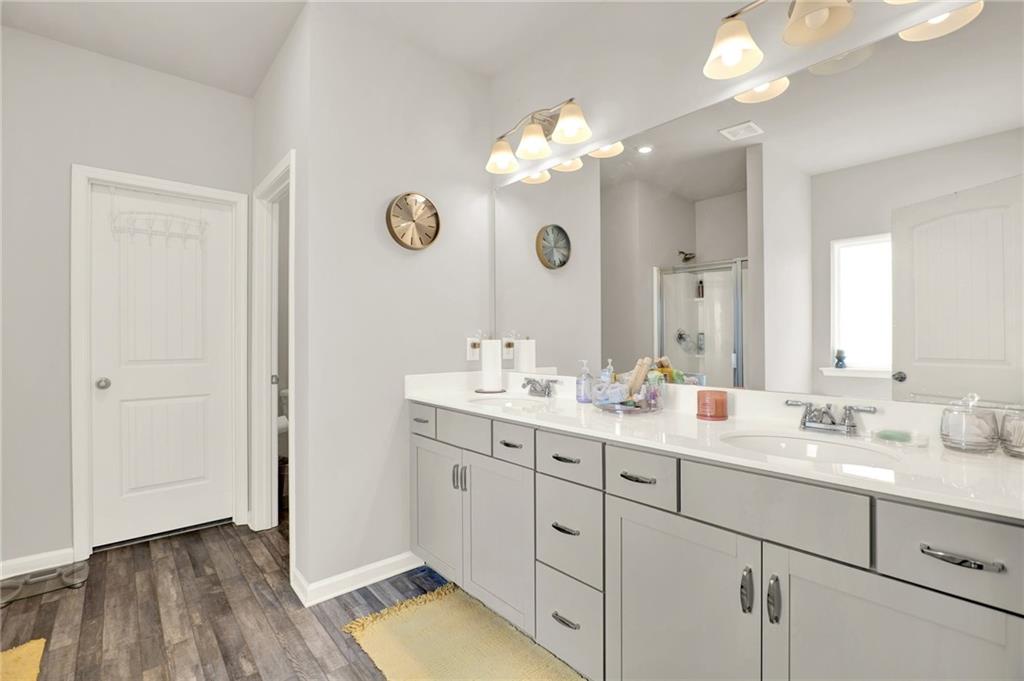25 Thacker Trail Adairsville, GA 30103 - Photo 28 of 47 a bathroom with a double vanity sink and a mirror