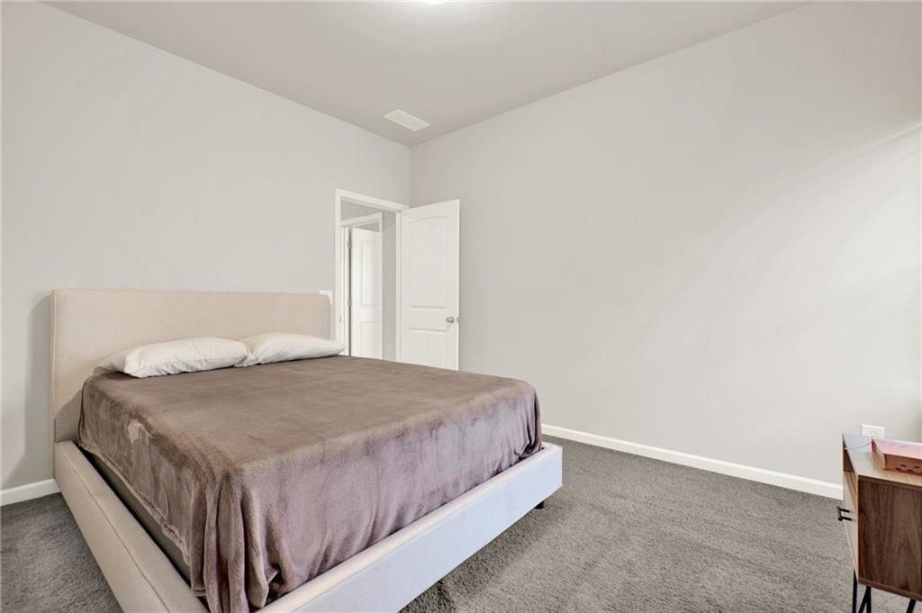 25 Thacker Trail Adairsville, GA 30103 - Photo 32 of 47 a bedroom with a bed and a night stand