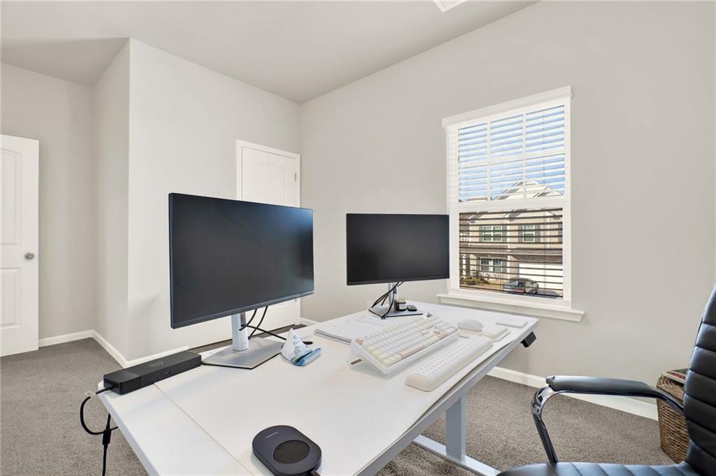 25 Thacker Trail Adairsville, GA 30103 - Photo 34 of 47 a view of a workspace with a flat screen tv and a window