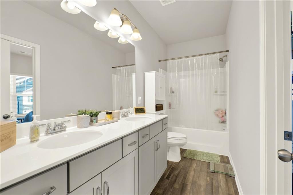 25 Thacker Trail Adairsville, GA 30103 - Photo 38 of 47 a bathroom with a double vanity sink a toilet and a mirror