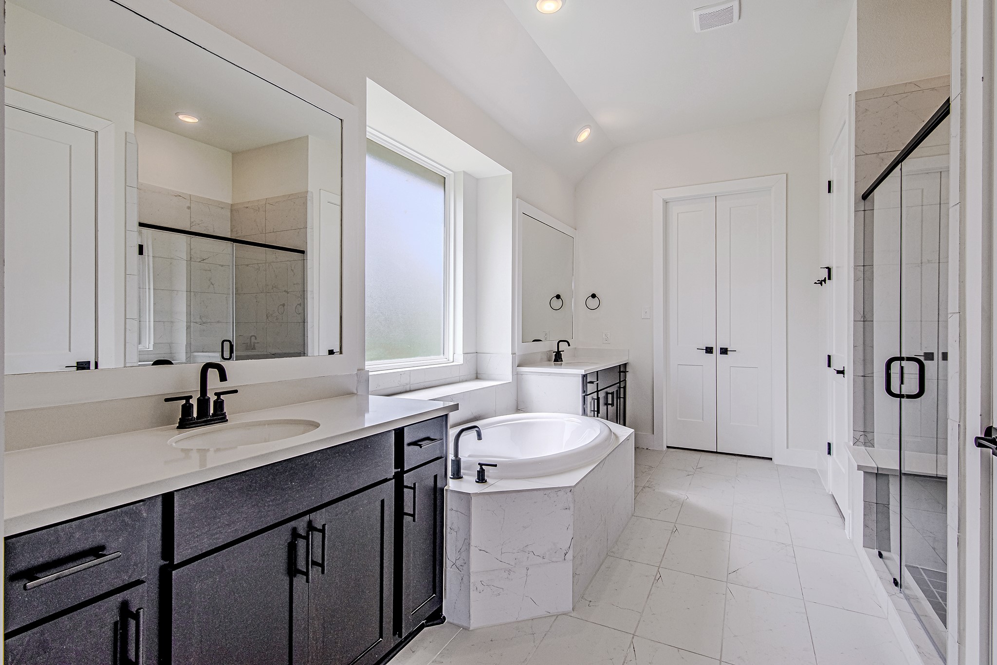157 Peninsula Point Drive Montgomery, TX 77356 - Photo 17 of 33 a bathroom with a double vanity sink toilet mirror and bathtub