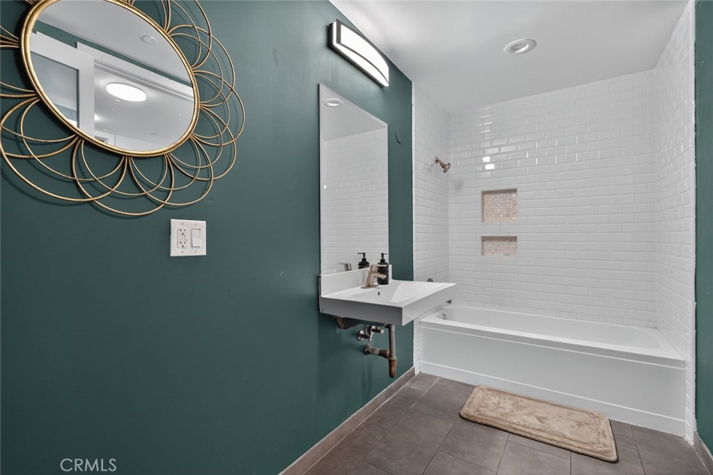 433 Pine Avenue, Unit 102 Long Beach, CA 90802 - Photo 22 of 60 a bathroom with a sink a light fixture and a mirror