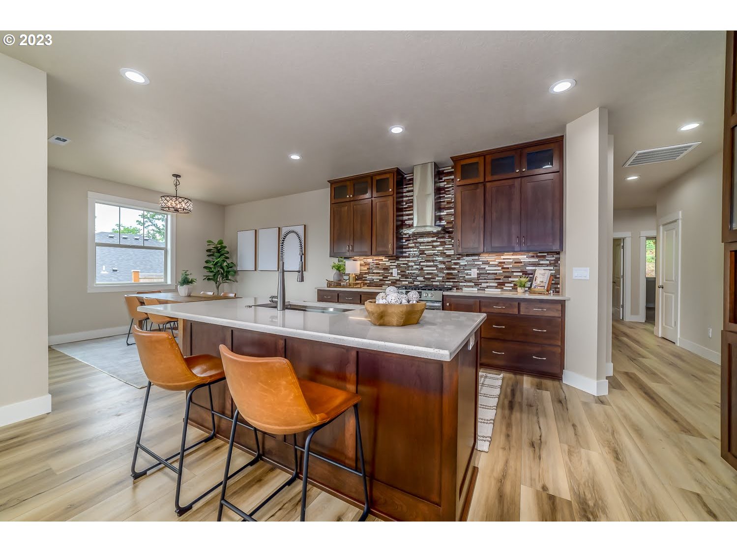 361 Mountaingate Drive Springfield, OR 97478 - Photo 12 of 35 a kitchen with stainless steel appliances kitchen island granite countertop a table chairs sink and cabinets
