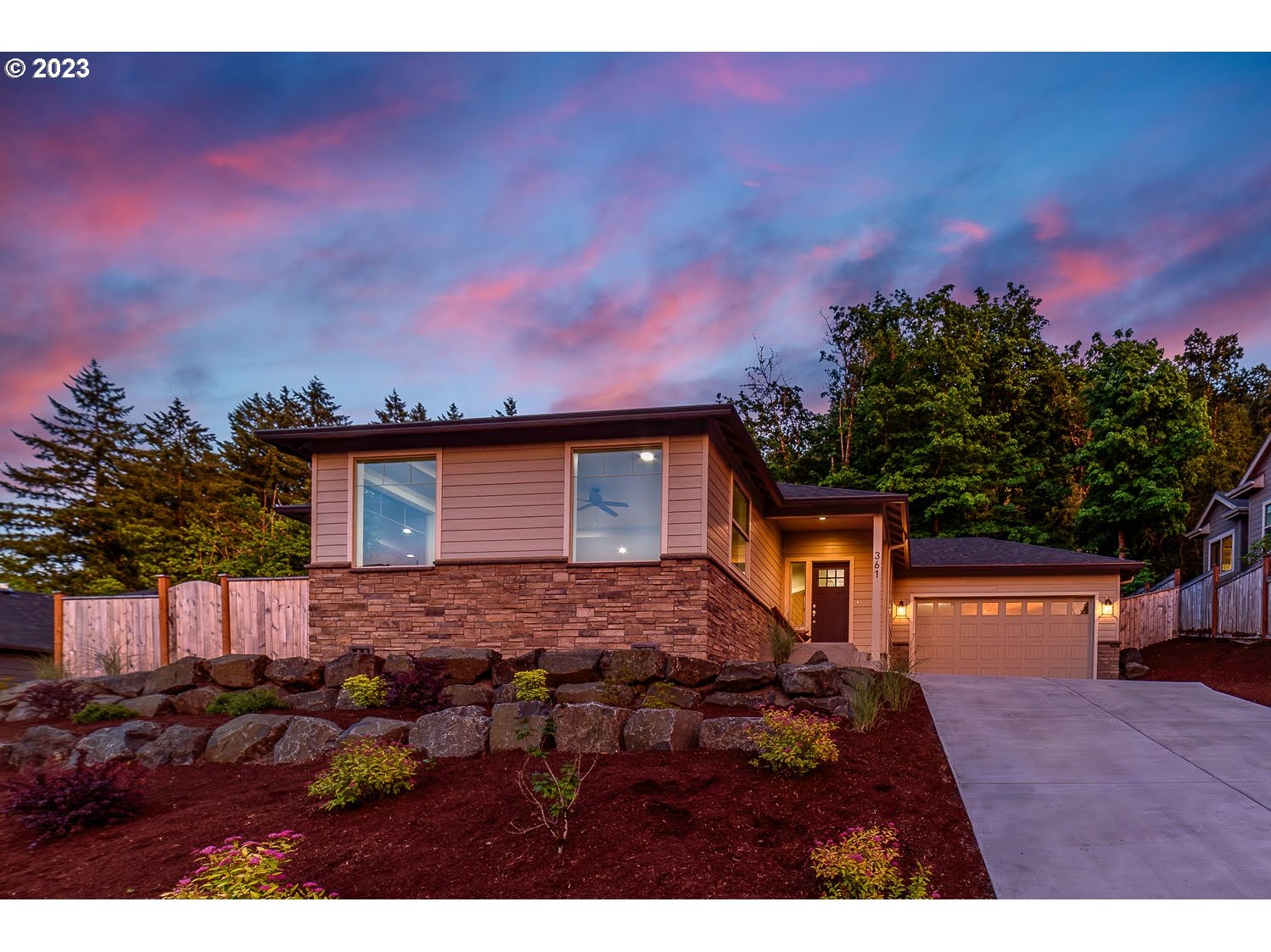 361 Mountaingate Drive Springfield, OR 97478 - Photo 2 of 35 a backyard of a house with table and chairs