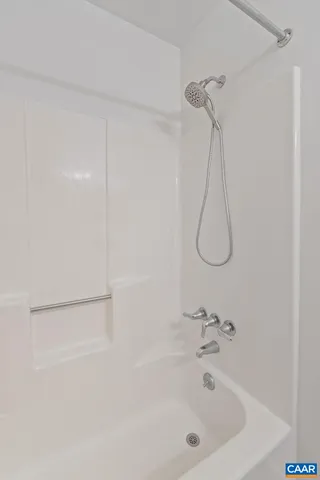 a bathroom with a bath tub and a shower