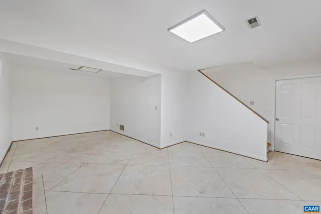 a view of an empty room with a ceiling fan