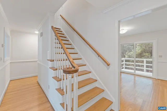 a view of entryway with wooden floor and stairs