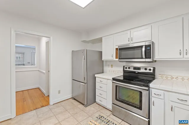 a kitchen with a refrigerator stove and microwave
