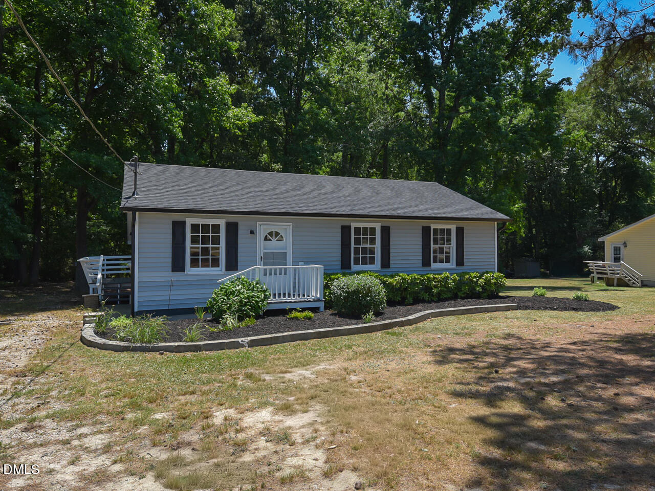 939 Cheves Road Zebulon, NC 27597 - Photo 2 of 21 a view of a house with backyard and trees