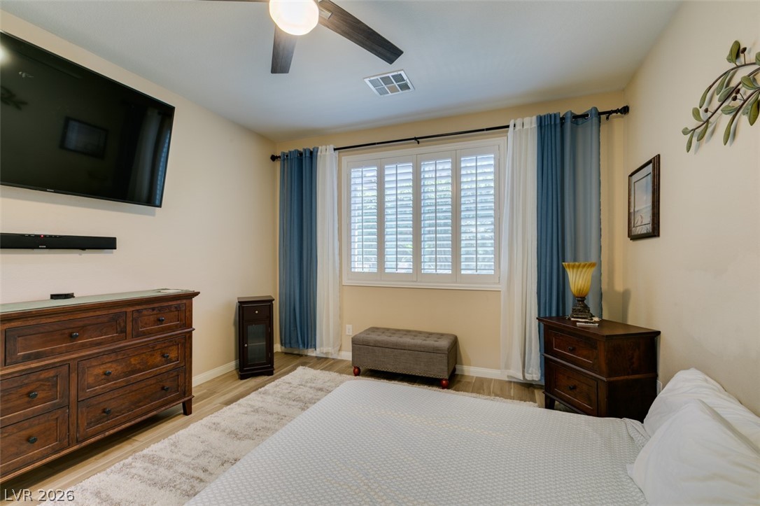 7375 Campbell Ranch Avenue Las Vegas, NV 89179 - Photo 25 of 45 Relax in this tranquil bedroom, offering elegant window shutters and a practical ceiling fan.