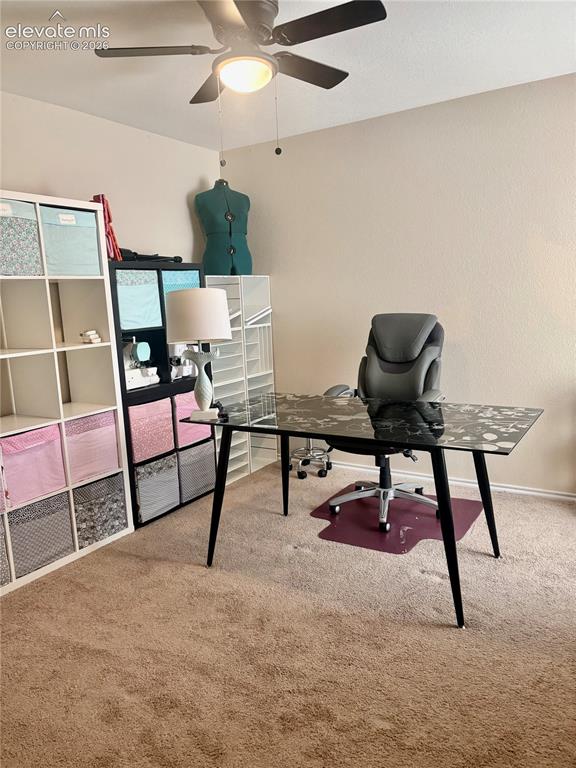 3748 Riviera Grove, Unit 203 Colorado Springs, CO 80922 - Photo 17 of 26 a workspace with furniture and a rug