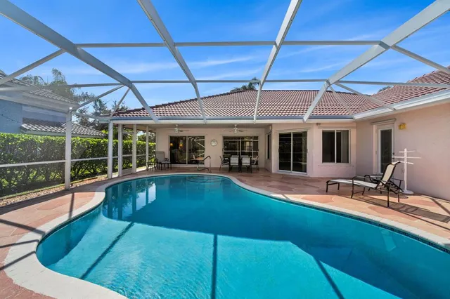 a view of a house with pool and chairs
