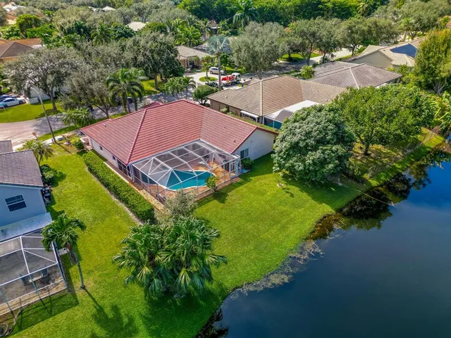an aerial view of a house with a garden and swimming pool
